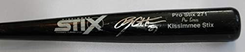 Ryon Healy Game autografado usou Black Kissimmee Stix Bat com prova, foto de Ryon assinando para
